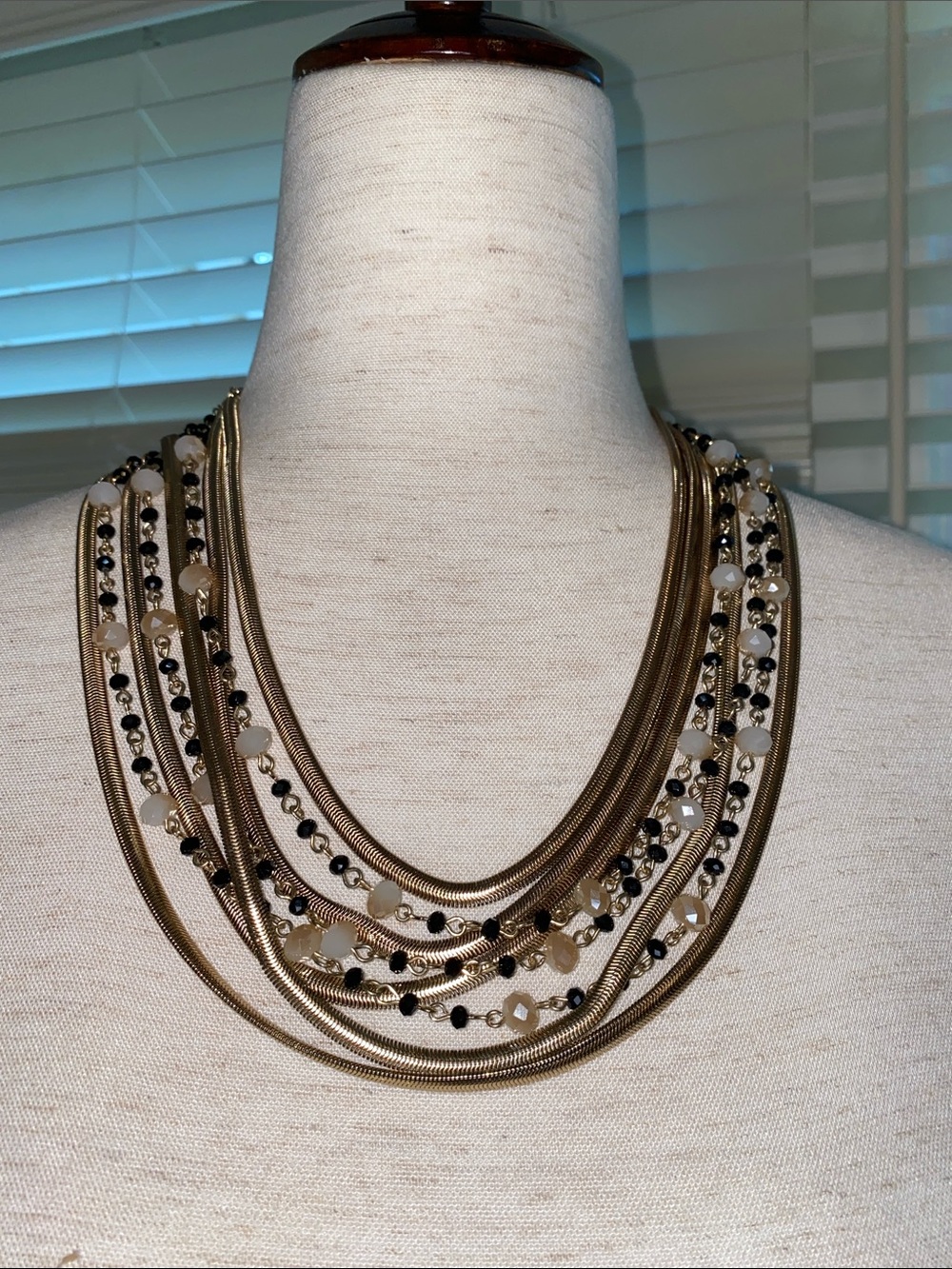 Multi-Strand Gold Tone Layered Necklace with Black and Cream Beads
